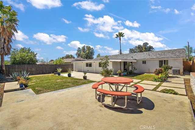 rear view of house with a patio, stucco siding, and central AC