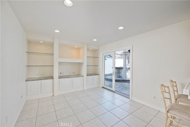 unfurnished dining area with light tile patterned floors, baseboards, recessed lighting, and built in shelves