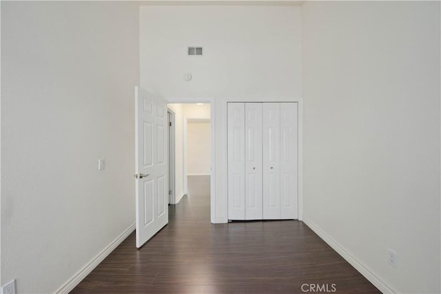 9788 Balaton St, Rancho Cucamonga, CA 91737 - unfurnished bedroom with dark wood-style flooring, a high ceiling, and a closet