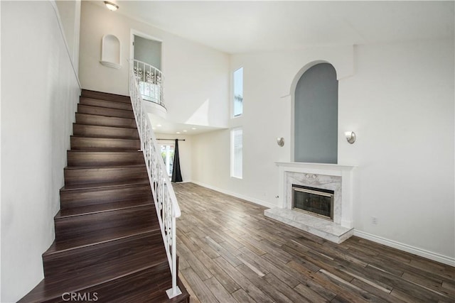 9788 Balaton St, Rancho Cucamonga, CA 91737 - stairs featuring wood finished floors, a high end fireplace, and a towering ceiling