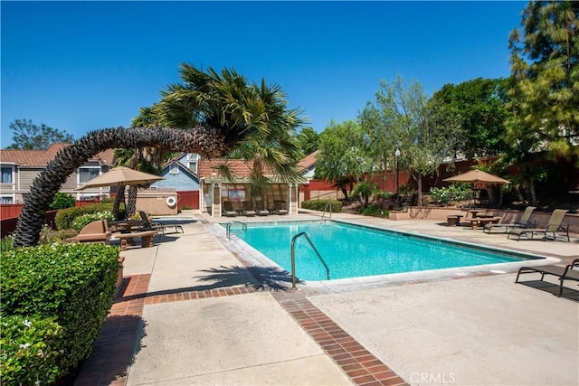 community pool featuring a patio and fence