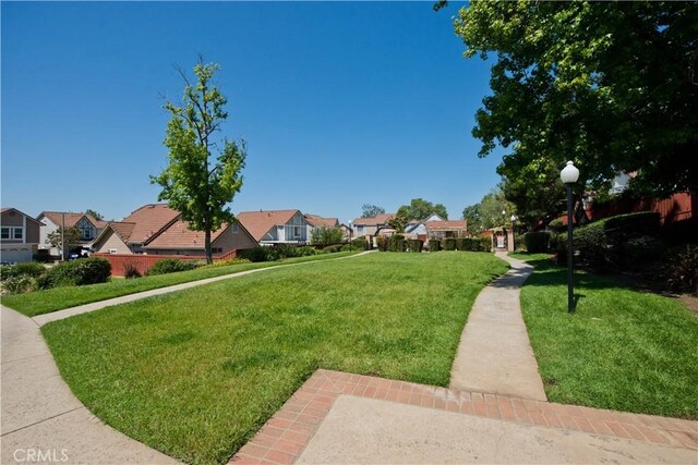 view of community featuring a residential view and a yard