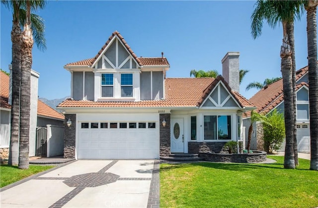view of front of home with a tile roof, stone siding, driveway, and a front lawn