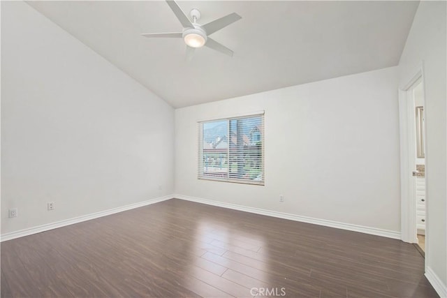 unfurnished room featuring vaulted ceiling, a ceiling fan, dark wood finished floors, and baseboards