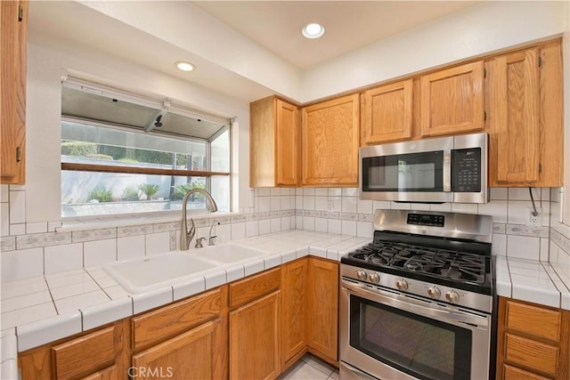 9788 Balaton St, Rancho Cucamonga, CA 91737 - kitchen with appliances with stainless steel finishes, tasteful backsplash, recessed lighting, and tile countertops