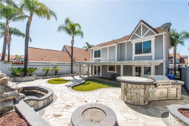 9788 Balaton St, Rancho Cucamonga, CA 91737 - back of house with a tile roof, area for grilling, a fenced backyard, and stucco siding
