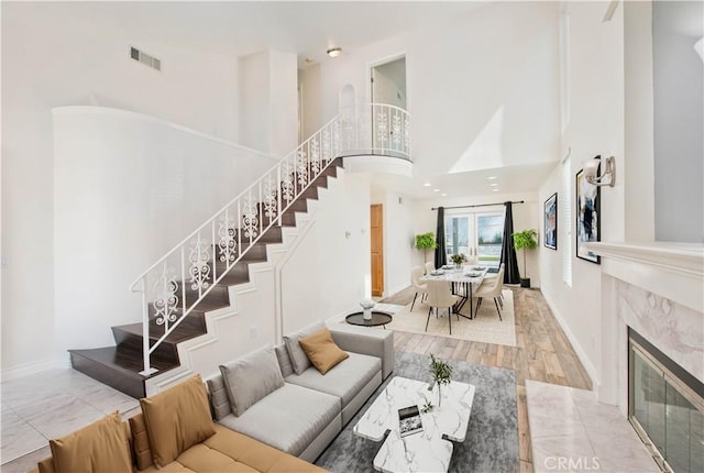 9788 Balaton St, Rancho Cucamonga, CA 91737 - living room featuring stairs, a high ceiling, and a premium fireplace