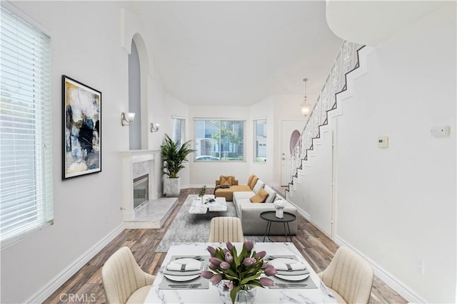 9788 Balaton St, Rancho Cucamonga, CA 91737 - living room with stairway, arched walkways, wood finished floors, and a high end fireplace