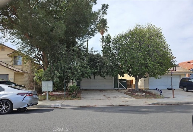 24383 Katrina Ave, Moreno Valley, CA 92551 - obstructed view of property with driveway and an attached garage