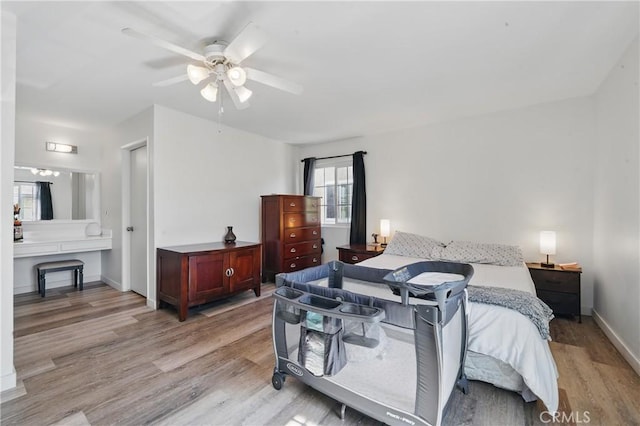 13722 Cerise Ave, Hawthorne, CA 90250 - bedroom with light wood finished floors, baseboards, and ceiling fan