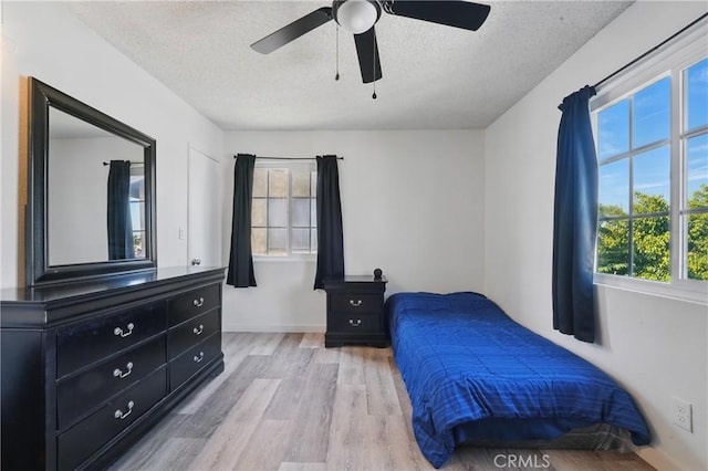 13722 Cerise Ave, Hawthorne, CA 90250 - bedroom with a textured ceiling, light wood-style flooring, a ceiling fan, and baseboards