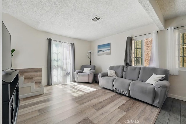 13722 Cerise Ave, Hawthorne, CA 90250 - living area with a textured ceiling, light wood-style flooring, and baseboards