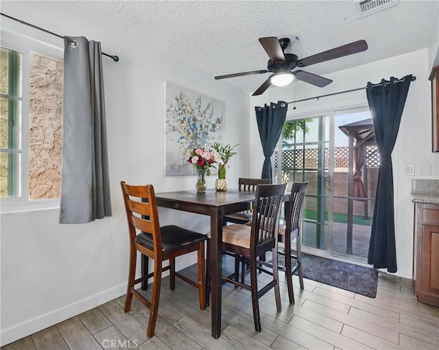 13722 Cerise Ave, Hawthorne, CA 90250 - dining area featuring light wood finished floors, ceiling fan, a textured ceiling, and baseboards