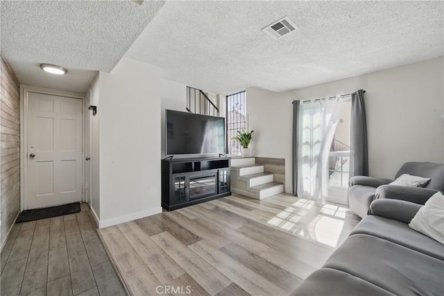 13722 Cerise Ave, Hawthorne, CA 90250 - living area with stairs, wood finished floors, a textured ceiling, and baseboards