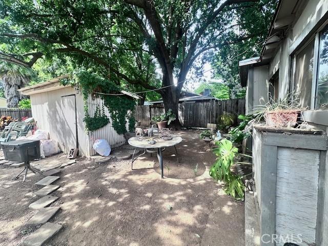 1414 Almond St, Chico, CA 95928 - view of patio / terrace with a fenced backyard, a storage shed, and an outdoor structure