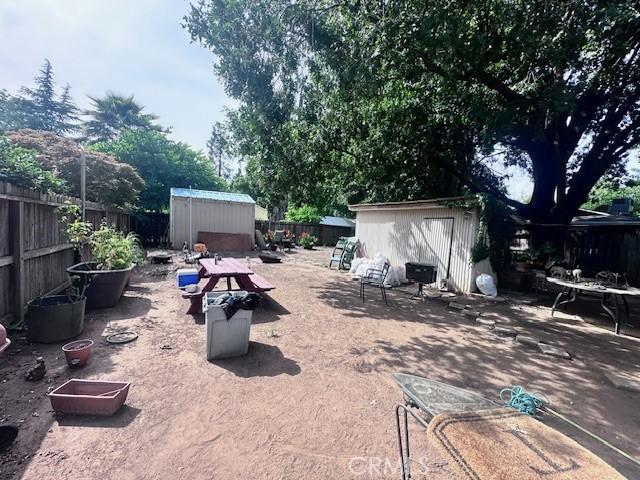 1414 Almond St, Chico, CA 95928 - fenced backyard featuring a shed and an outdoor structure