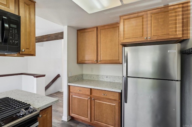 514 Jamacha Rd Unit 17, El Cajon, CA 92019 - kitchen featuring appliances with stainless steel finishes, dark wood-style flooring, brown cabinets, and light stone countertops
