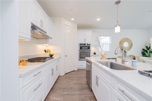 24716 Acadia Dr, Corona, CA 92883 - kitchen featuring a sink, under cabinet range hood, stainless steel appliances, white cabinetry, and recessed lighting