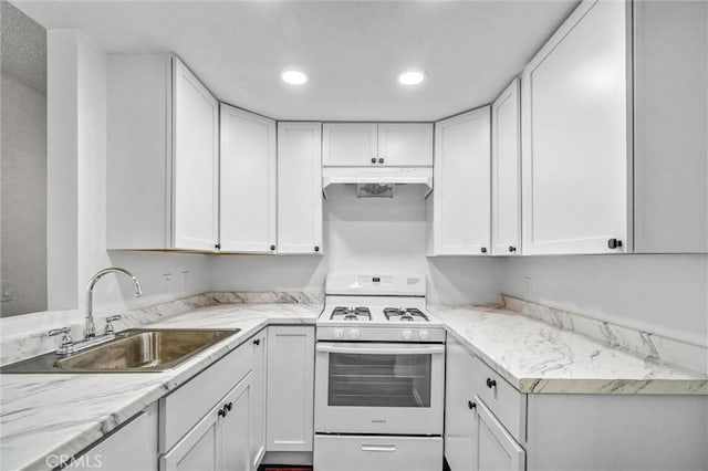 600 W 3rd St Unit A115, Santa Ana, CA 92701 - kitchen with white gas range oven, a sink, under cabinet range hood, white cabinetry, and recessed lighting