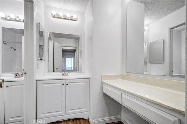 600 W 3rd St Unit A115, Santa Ana, CA 92701 - bathroom featuring a textured ceiling, two vanities, and a shower