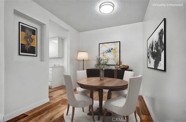 600 W 3rd St Unit A115, Santa Ana, CA 92701 - dining room featuring baseboards and light wood finished floors