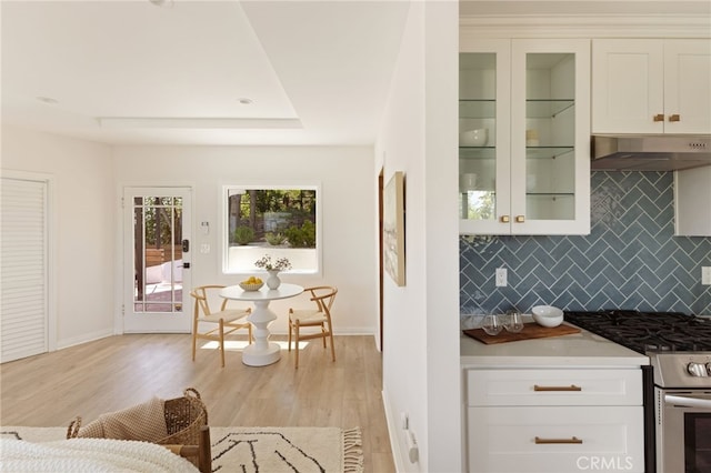 479 Crane Blvd, Los Angeles, CA 90065 - kitchen featuring stainless steel gas range, decorative backsplash, light wood-type flooring, under cabinet range hood, and baseboards