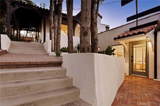 479 Crane Blvd, Los Angeles, CA 90065 - view of exterior entry with a tile roof and stucco siding