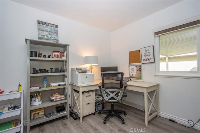 home office with wood finished floors and baseboards