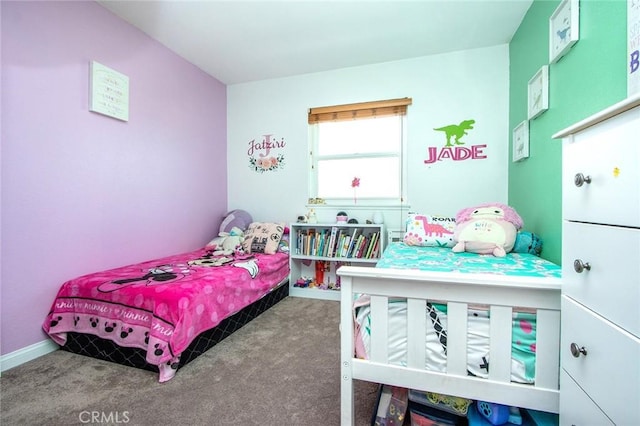 carpeted bedroom featuring baseboards