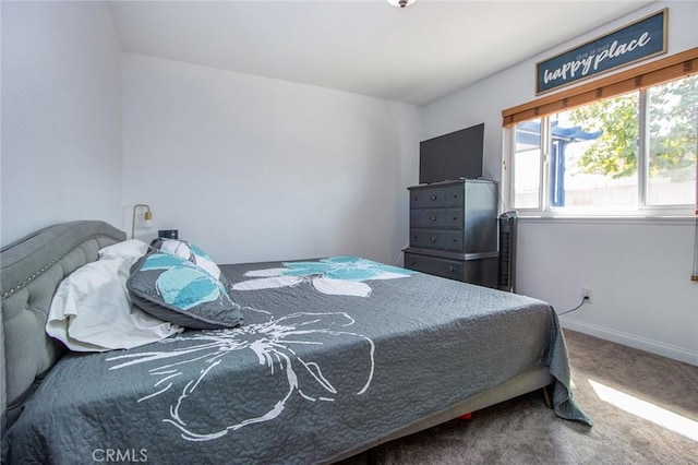 bedroom with carpet and baseboards