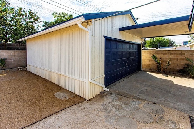 detached garage featuring fence