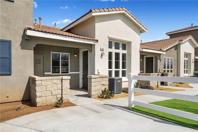 986 Coriander Dr Unit 304, Hemet, CA 92545 - view of front of house with central AC, stucco siding, and a tile roof