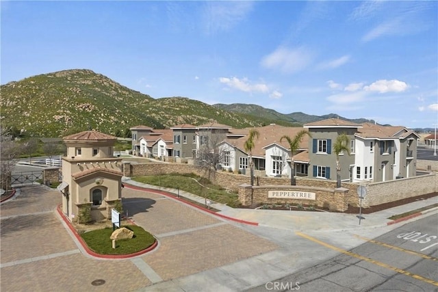 986 Coriander Dr Unit 304, Hemet, CA 92545 - view of front of property with stucco siding, a mountain view, and a residential view