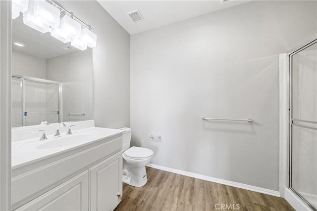 986 Coriander Dr Unit 304, Hemet, CA 92545 - full bathroom featuring a stall shower, wood finished floors, toilet, and vanity