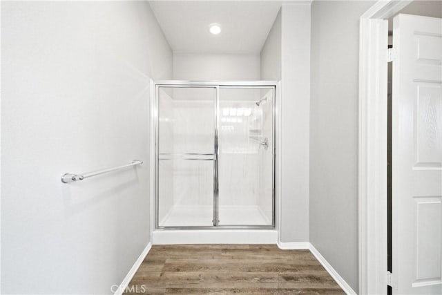 986 Coriander Dr Unit 304, Hemet, CA 92545 - bathroom with a stall shower, wood finished floors, and baseboards