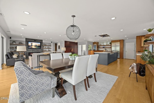 dining space with recessed lighting and light wood finished floors