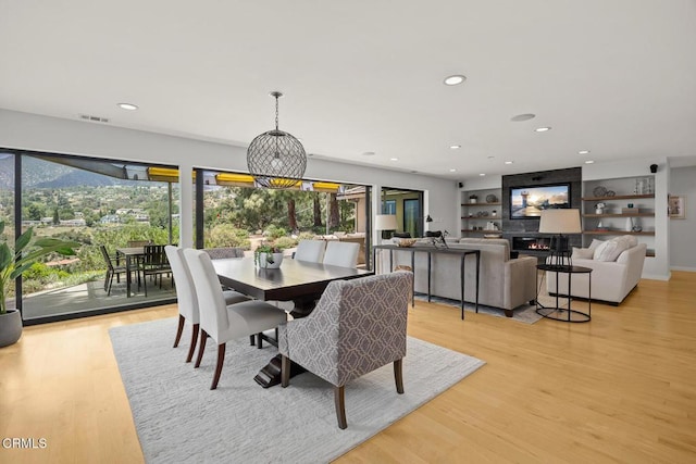 dining space with plenty of natural light, light wood finished floors, and recessed lighting