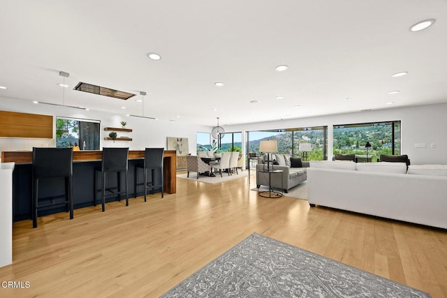 living room featuring light wood finished floors and recessed lighting