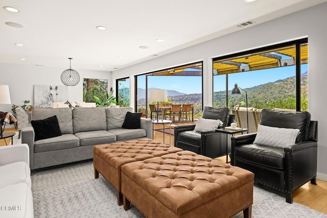 living area featuring light wood-style floors, a mountain view, and recessed lighting
