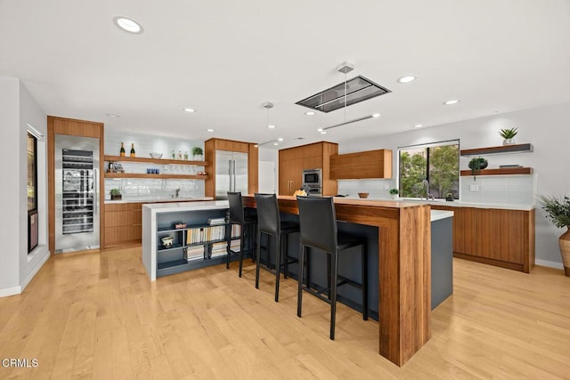 kitchen featuring open shelves, built in appliances, modern cabinets, brown cabinets, and recessed lighting