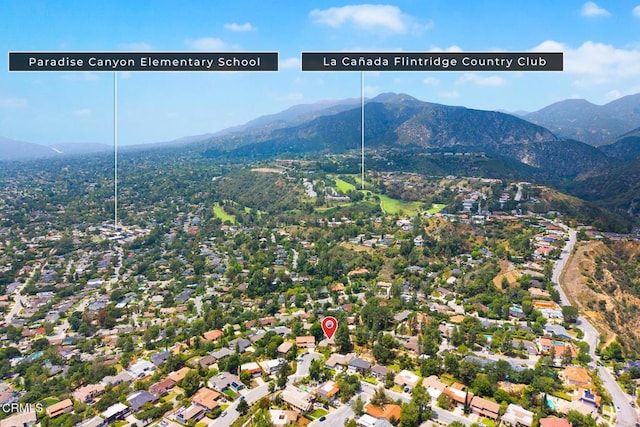 aerial overview of property's location with a mountainous background