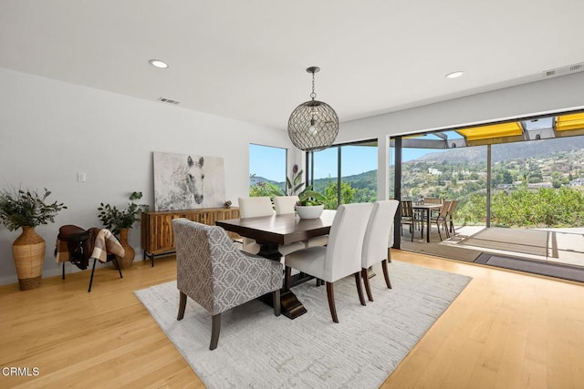 dining area with light wood-type flooring and recessed lighting