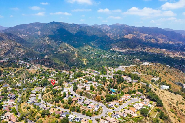 aerial view of property and surrounding area featuring mountains