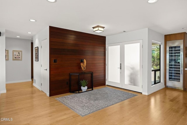 entrance foyer featuring baseboards, light wood-style flooring, recessed lighting, beverage cooler, and french doors