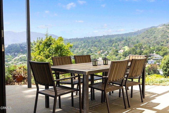 view of patio featuring a mountain view and outdoor dining area