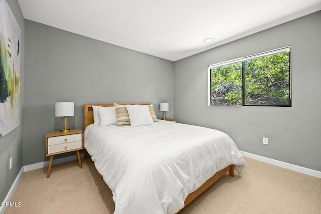 bedroom featuring carpet and baseboards