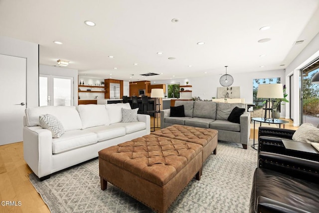living room featuring light wood-type flooring and recessed lighting
