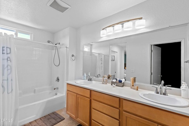 2024 Green Ridge Cir, Lompoc, CA 93436 - bathroom with shower / bath combination with curtain, double vanity, and a textured ceiling