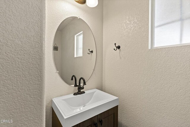 2024 Green Ridge Cir, Lompoc, CA 93436 - bathroom featuring vanity, a textured wall, and healthy amount of natural light