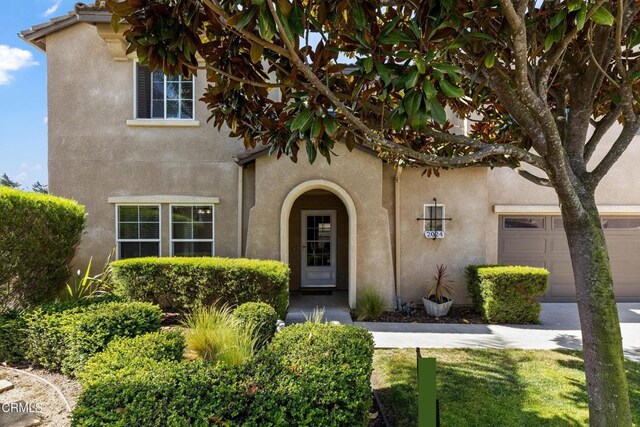 2024 Green Ridge Cir, Lompoc, CA 93436 - doorway to property with stucco siding and a garage